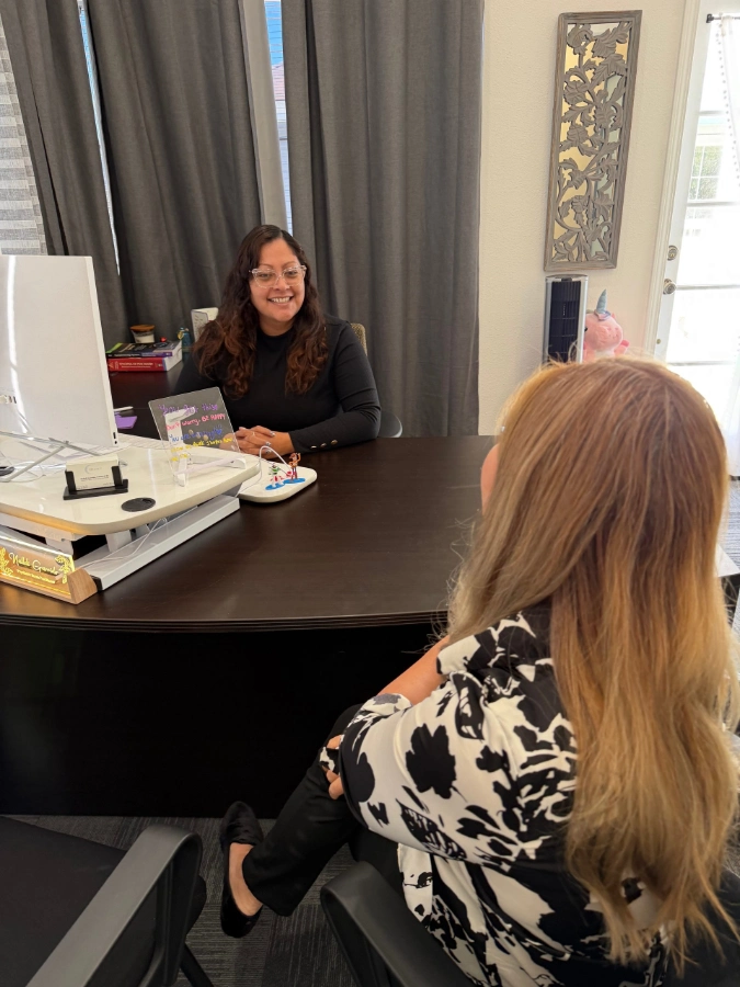 Two board-certified psychiatric nurse practitioners collaborating on a patient treatment plan at our Garden Grove clinic.