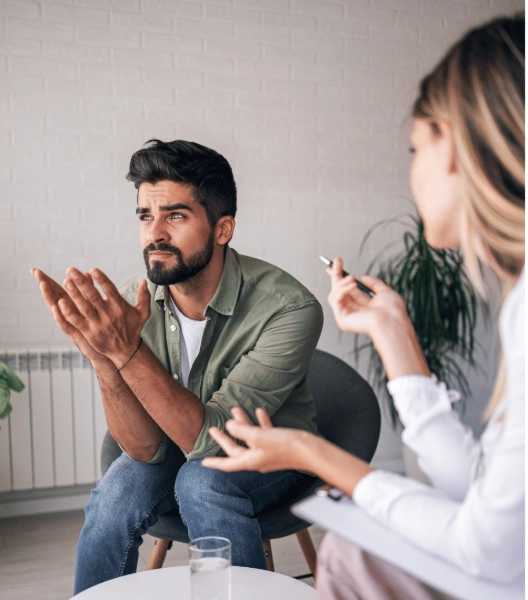 A mental health professional and patient discussing diagnostic findings to build a specialized treatment plan.